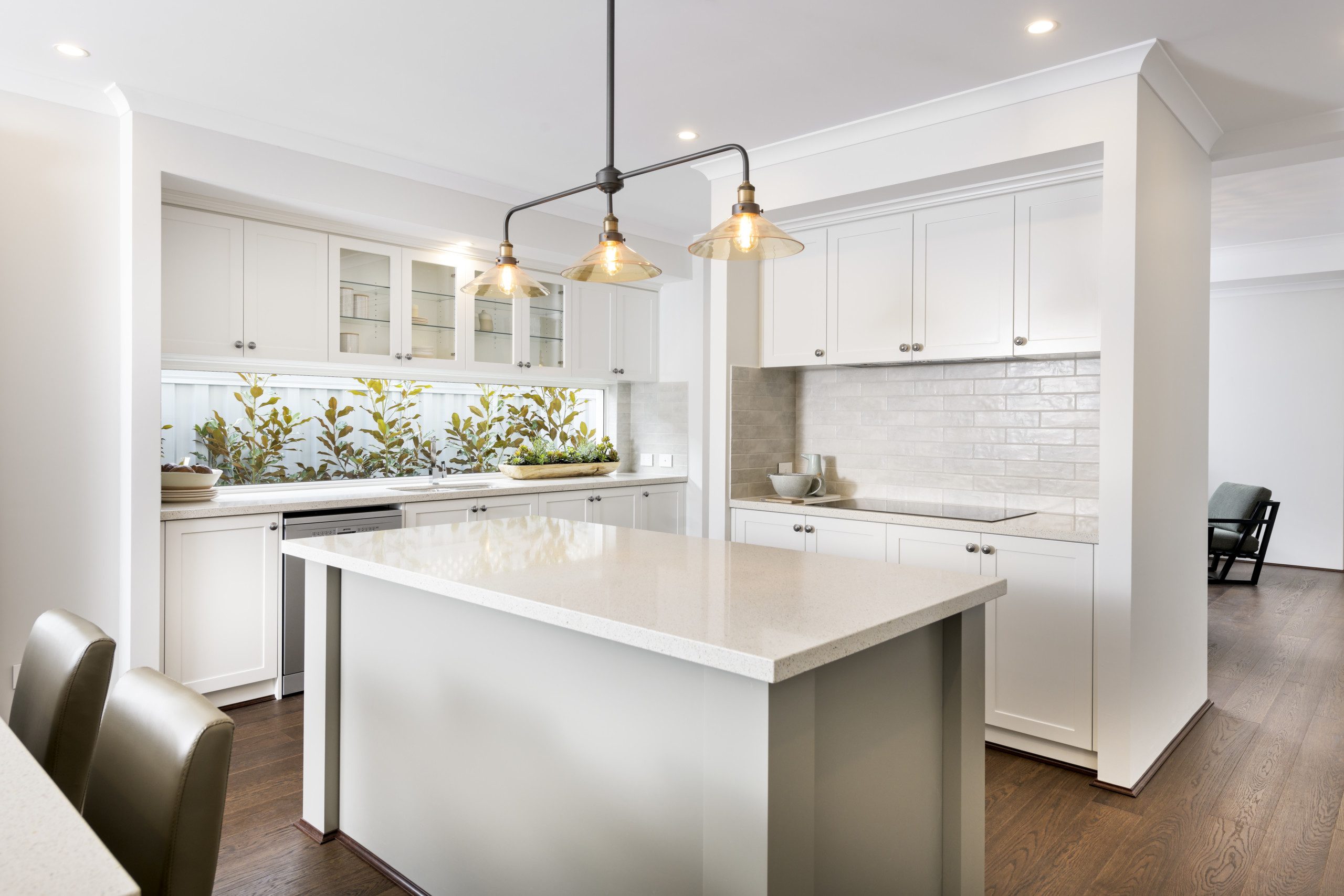 White hamptons style kitchen with white cabinets, white subway tile and white stone benchtops
