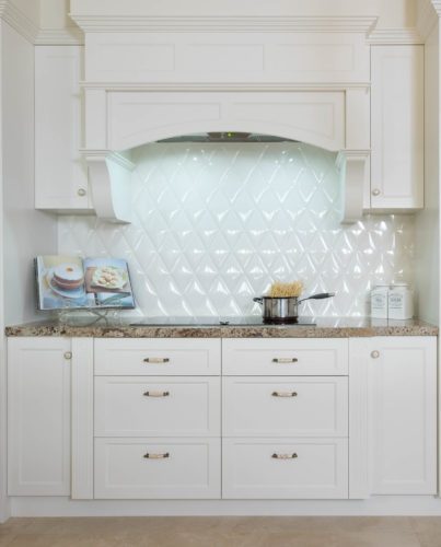 White kitchen cabinets with white splash back tiles
